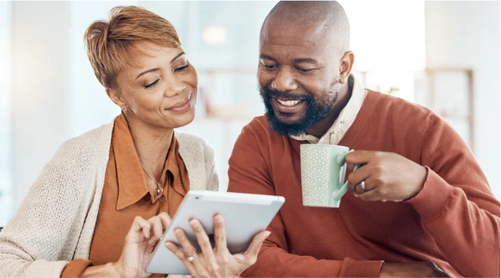 Man and woman looking at finances on tablet