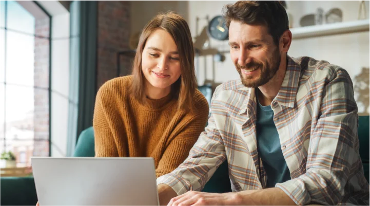 Man and woman looking at finances on computer